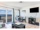 Living room with ocean view, dining table, and TV at 6000 N Ocean Blvd. # 205, North Myrtle Beach, SC 29582