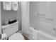 Small bathroom with toilet, shower, and white tile at 601 Retreat Beach Circle # 124, Pawleys Island, SC 29585