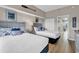 Bright bedroom with two twin beds, dresser, and ocean-themed decor at 601 Retreat Beach Circle # 124, Pawleys Island, SC 29585