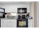 Kitchen boasts granite countertops and black appliances at 601 Retreat Beach Circle # 124, Pawleys Island, SC 29585