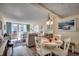 Charming dining area with white table and chairs, adjacent to living room at 601 Retreat Beach Circle # 328, Litchfield, SC 29585