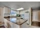 L-shaped kitchen featuring granite countertops and white cabinetry at 601 Retreat Beach Circle # 328, Litchfield, SC 29585