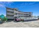 Pelican Pass building exterior, two-story with gray siding and balconies at 612 S Ocean Blvd. # 104A, Surfside Beach, SC 29575