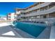 Pelican Pass community pool with lounge chairs and a fence at 612 S Ocean Blvd. # 104A, Surfside Beach, SC 29575