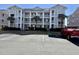 Three-story building exterior with parking lot and landscaping at 636 Waterway Village Blvd. # 17C, Myrtle Beach, SC 29579