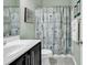 Clean bathroom with a shower/tub combo, dark vanity, and beach-themed decor at 834 Arezzo Way # 834, Myrtle Beach, SC 29579