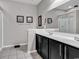 Modern bathroom with dual vanity sinks, a large mirror, and a walk-in shower at 834 Arezzo Way # 834, Myrtle Beach, SC 29579