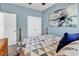 Bedroom with a wooden bed frame, double door closet, and wall art at 834 Arezzo Way # 834, Myrtle Beach, SC 29579