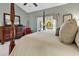 Primary bedroom with a king-size bed, dresser, and access to a private patio at 834 Arezzo Way # 834, Myrtle Beach, SC 29579
