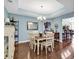 Bright dining room with hardwood floors, a chandelier, and a view of the kitchen at 834 Arezzo Way # 834, Myrtle Beach, SC 29579