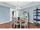 Bright dining room features hardwood floors, a wood table, and coordinating chairs at 834 Arezzo Way # 834, Myrtle Beach, SC 29579