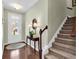 Bright and spacious entryway with hardwood floors, a console table, and stairs leading upstairs at 834 Arezzo Way # 834, Myrtle Beach, SC 29579