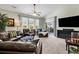 Relaxing living room featuring comfortable seating and a large TV at 834 Arezzo Way # 834, Myrtle Beach, SC 29579