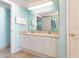 Bathroom featuring double sink with white cabinets and door to toilet at 8560 Queensway Blvd. # 1210, Myrtle Beach, SC 29572