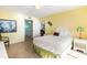 Bright bedroom with yellow walls, a white wicker headboard, and an ensuite bathroom at 8560 Queensway Blvd. # 1210, Myrtle Beach, SC 29572