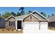 Brick and stone front elevation, three-car garage, and landscaping at 920 Belle Dr., North Myrtle Beach, SC 29582