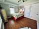 Coastal-themed bedroom with hardwood floors and a ceiling fan at 923 N Waccamaw Dr., Garden City Beach, SC 29576