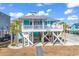 Charming elevated beach house with a spacious deck and ocean views at 923 N Waccamaw Dr., Garden City Beach, SC 29576