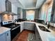Well-equipped kitchen featuring modern appliances and white cabinets at 923 N Waccamaw Dr., Garden City Beach, SC 29576