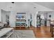 Open living room with hardwood floors, comfy seating, and TV at 923 N Waccamaw Dr., Garden City Beach, SC 29576