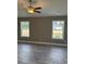 Bright bedroom with wood-look floors, ceiling fan, and large windows at Tbb14 Casey Dr., Green Sea, SC 29545