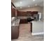 Modern kitchen boasts granite countertops and dark wood cabinets at Tbb14 Casey Dr., Green Sea, SC 29545