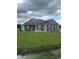 Newly constructed home with gray siding, dark roof and landscaping at Tbd 12 Casey Dr., Green Sea, SC 29545