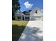 White two-story house with a large driveway and grassy yard at Tbd 13 Casey Dr., Green Sea, SC 29545