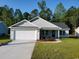 Newly constructed home with a white garage door and landscaping at Tbd11 Casey Dr., Green Sea, SC 29545