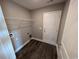 Laundry room with built-in shelving and dark laminate flooring at Tbd11 Casey Dr., Green Sea, SC 29545