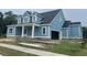Side view of a blue two-story house with an attached garage and an inviting front porch at 1004 James Island Ave., North Myrtle Beach, SC 29582