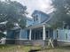 Side view of a blue home featuring a front porch with large pillars and second-story dormer windows at 1004 James Island Ave., North Myrtle Beach, SC 29582