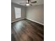 Bright bedroom with window, ceiling fan and dark brown luxury vinyl plank flooring at 1028 Seaside Dr., North Myrtle Beach, SC 29582