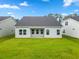 Well-maintained backyard with green grass and an exterior view of the rear of the home at 1099 Nw Forest Bend Dr., Calabash, NC 28467