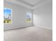 Bright bedroom with plush carpeting, neutral paint, and two windows that fill the space with light at 1099 Nw Forest Bend Dr., Calabash, NC 28467