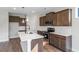 Modern kitchen with stainless steel appliances, wooden cabinets, a center island, and stylish backsplash at 1099 Nw Forest Bend Dr., Calabash, NC 28467