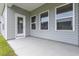 Covered patio with three large windows and a door that leads into the home at 1099 Nw Forest Bend Dr., Calabash, NC 28467