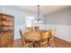 Round wooden dining table with chairs in bright dining room at 117 George Washington Trail, Georgetown, SC 29440