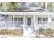 House exterior, showcasing a front porch with gray door at 117 George Washington Trail, Georgetown, SC 29440
