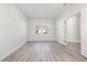 Bright, airy bedroom with wood-look flooring, a window, and a doorway leading to another room at 1336 Winding Creek Way, Myrtle Beach, SC 29588
