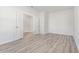 Open bedroom with wood-look floors, light gray walls, and connecting doorways to closet and hall at 1336 Winding Creek Way, Myrtle Beach, SC 29588