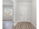 Bright entryway featuring a front door, wood-look flooring and view into a room with a window at 1336 Winding Creek Way, Myrtle Beach, SC 29588