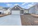 Gray house with white garage door and landscaping at 1336 Winding Creek Way, Myrtle Beach, SC 29588