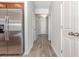Hallway featuring wood-look flooring, white walls, and a stainless steel refrigerator in background at 1336 Winding Creek Way, Myrtle Beach, SC 29588