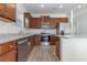 Open kitchen with stainless steel appliances, wooden cabinets, granite countertops, and tile flooring at 1336 Winding Creek Way, Myrtle Beach, SC 29588