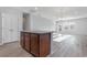 Kitchen island with wood cabinets, granite countertops and view to living area with lots of light at 1336 Winding Creek Way, Myrtle Beach, SC 29588