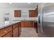Well-equipped kitchen featuring stainless steel appliances, granite countertops, and wooden cabinets at 1336 Winding Creek Way, Myrtle Beach, SC 29588