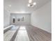 Bright living room with ample natural light and a modern light fixture, featuring wood flooring at 1336 Winding Creek Way, Myrtle Beach, SC 29588