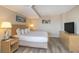 Comfortable bedroom features king bed, nightstands and dresser with tv at 1501 S Ocean Blvd. S # 1450, Myrtle Beach, SC 29577