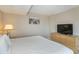 Comfortable bedroom features king bed and dresser with tv at 1501 S Ocean Blvd. S # 1450, Myrtle Beach, SC 29577